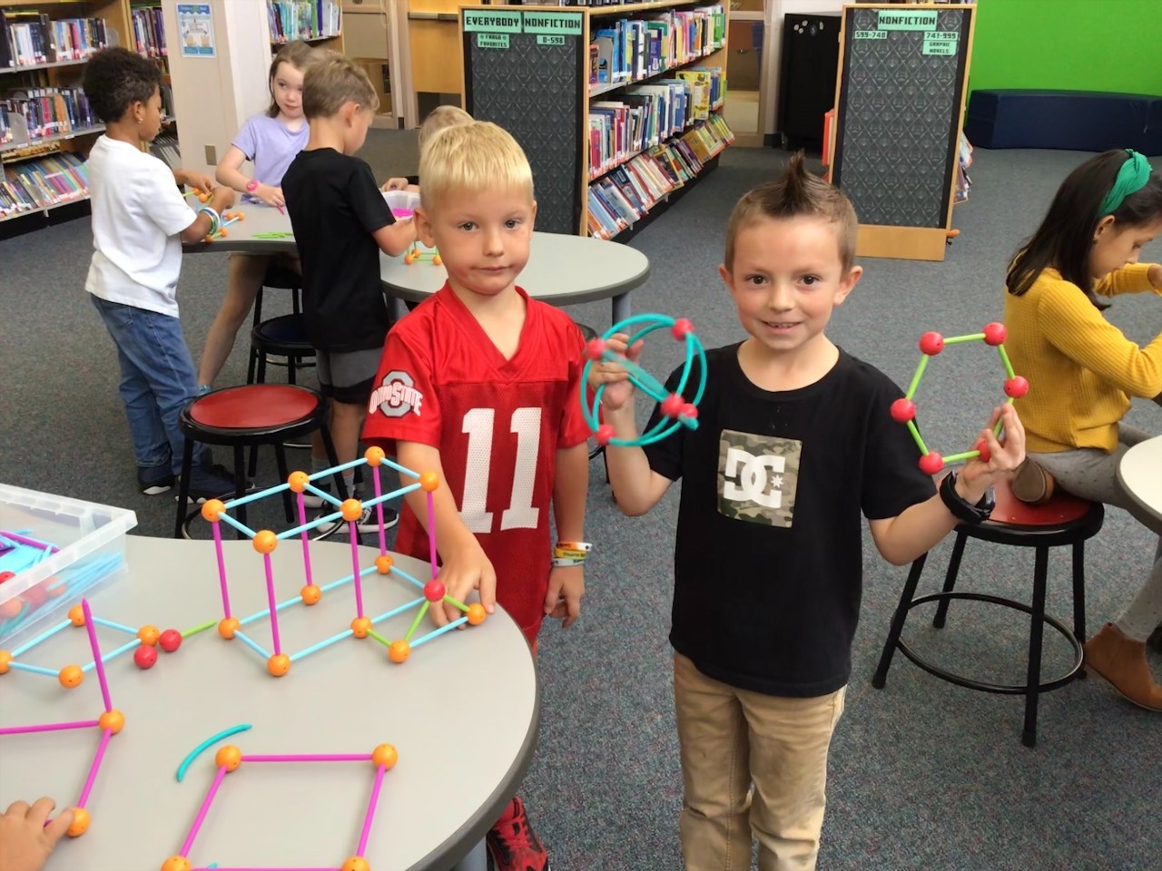 Two Boys standing with 3D Shapes: